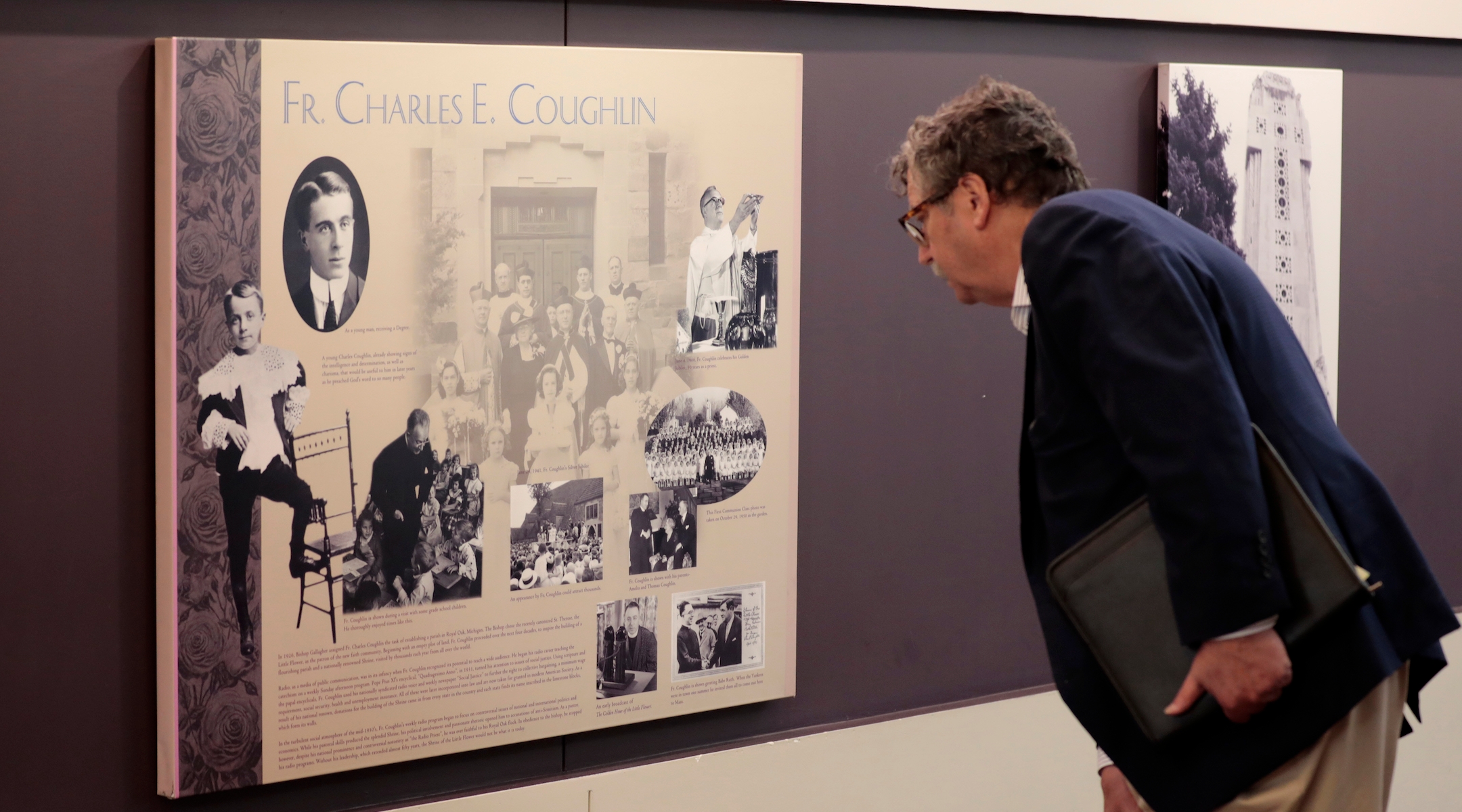 A man inspects a plaque