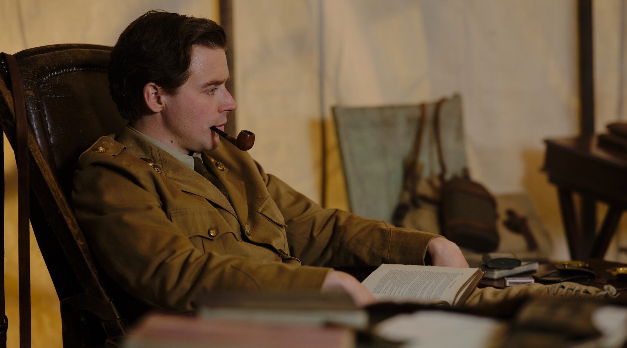 A man at a desk with a pipe