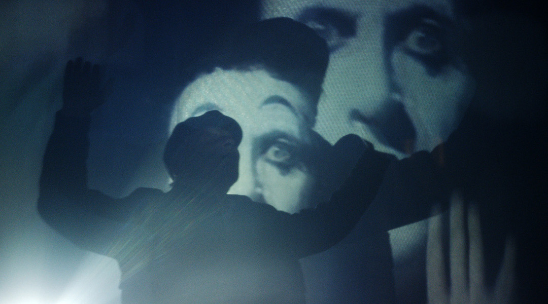 A man standing in front of a movie screen