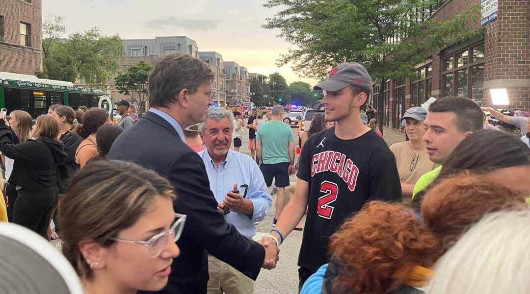 Rep. Brad Schneider, left, chats with a constituent