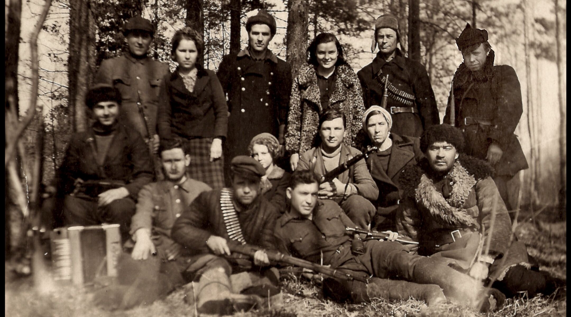 Armed fighters posing in the woods in a historical photo