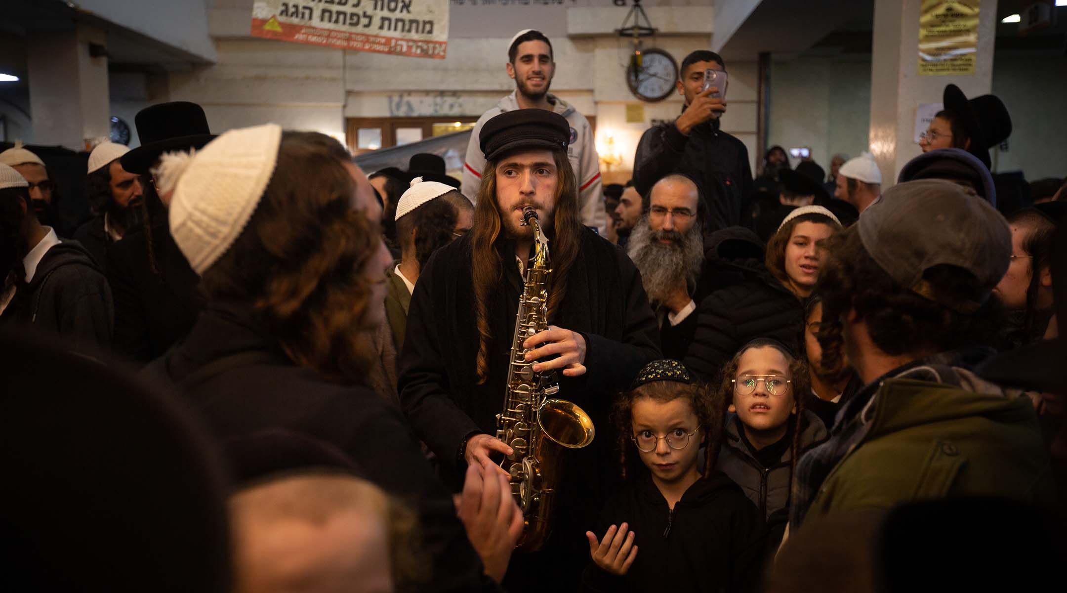 A man plays a saxophone.