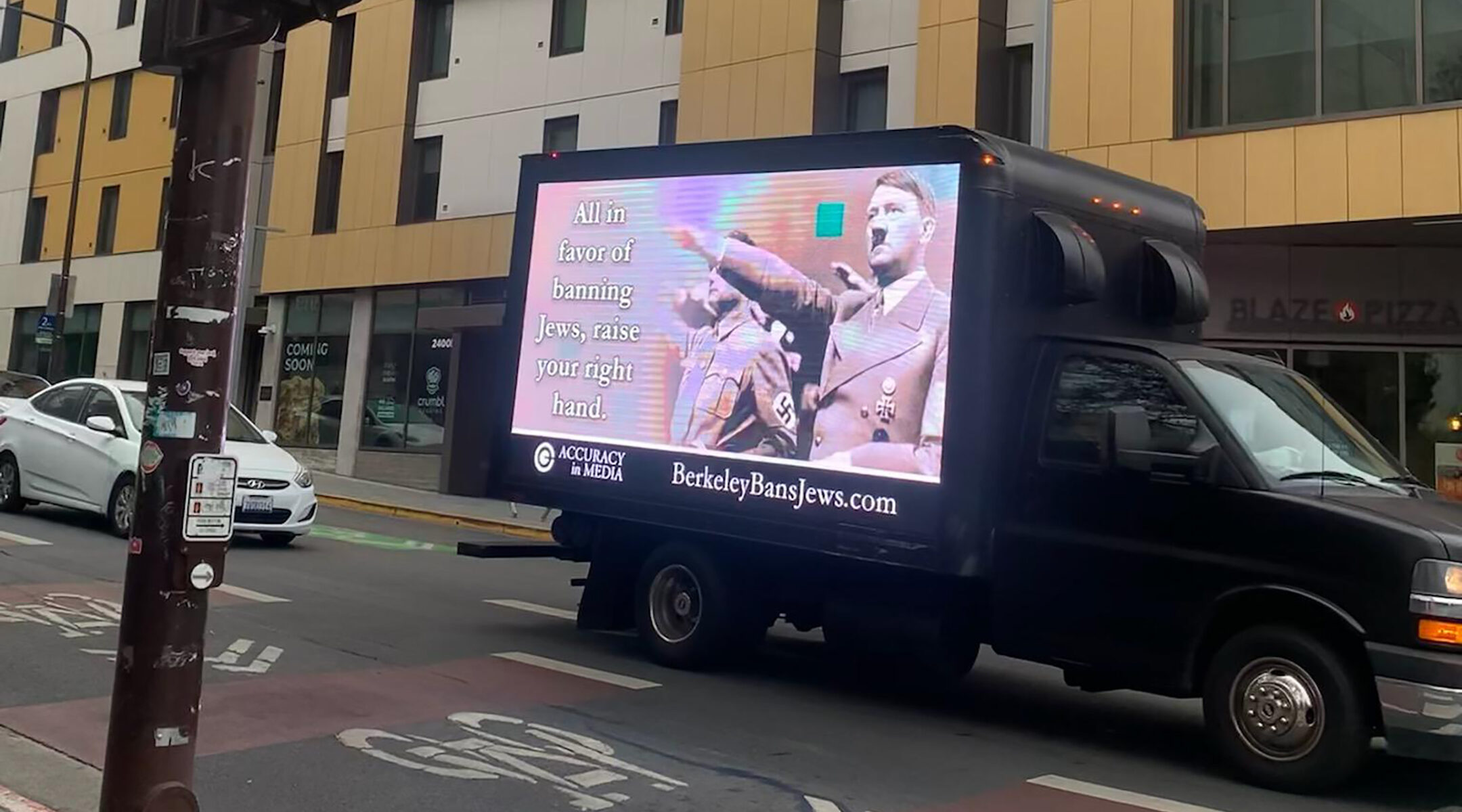 A truck emblazoned with an image of Adolf Hitler.