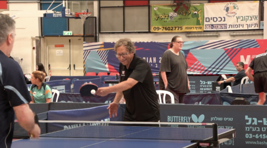 Stuart Weitzman playing ping pong