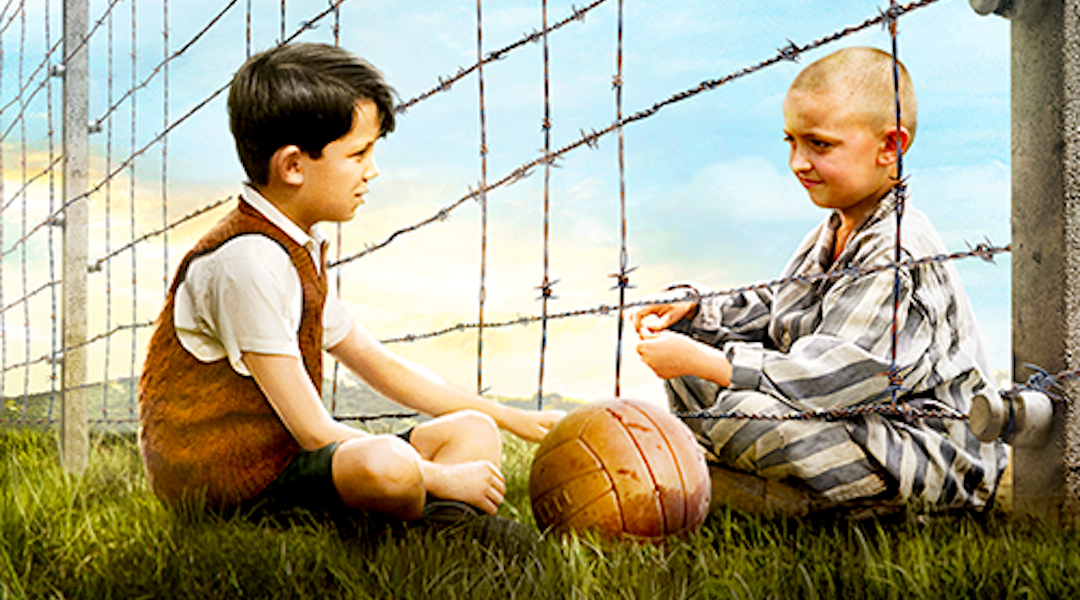 Two boys at a barbed-wire fence