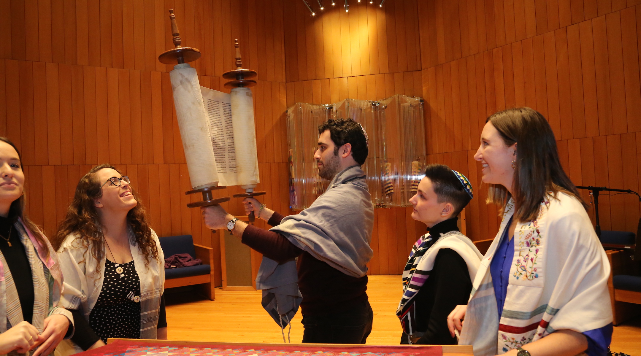A rabbi lifting a Torah