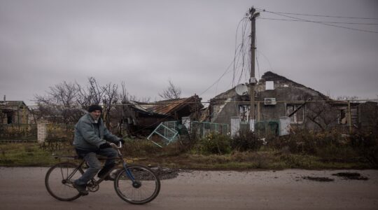 Man rides through destroyed Kherson