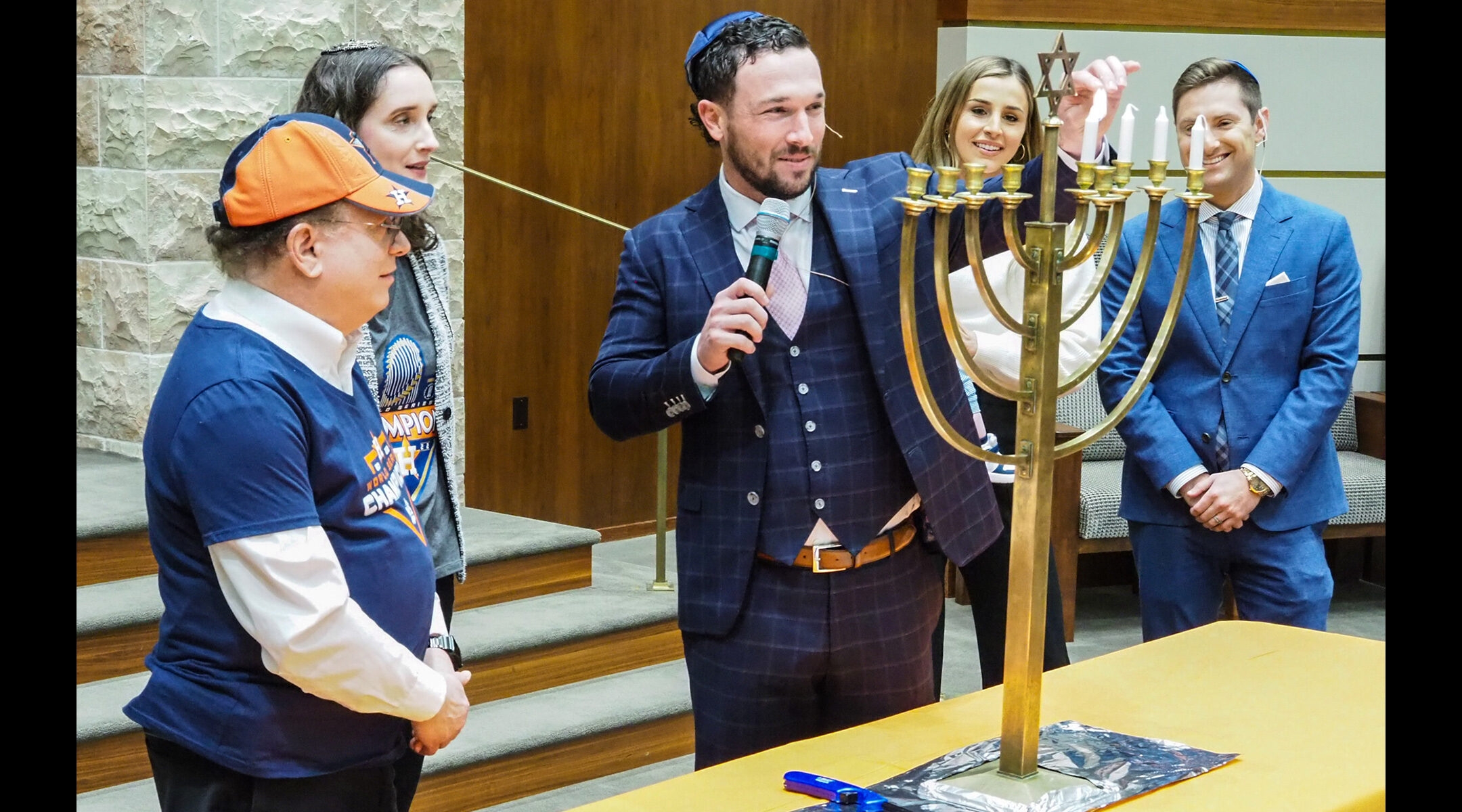 Alex Bregman lighting a menorah