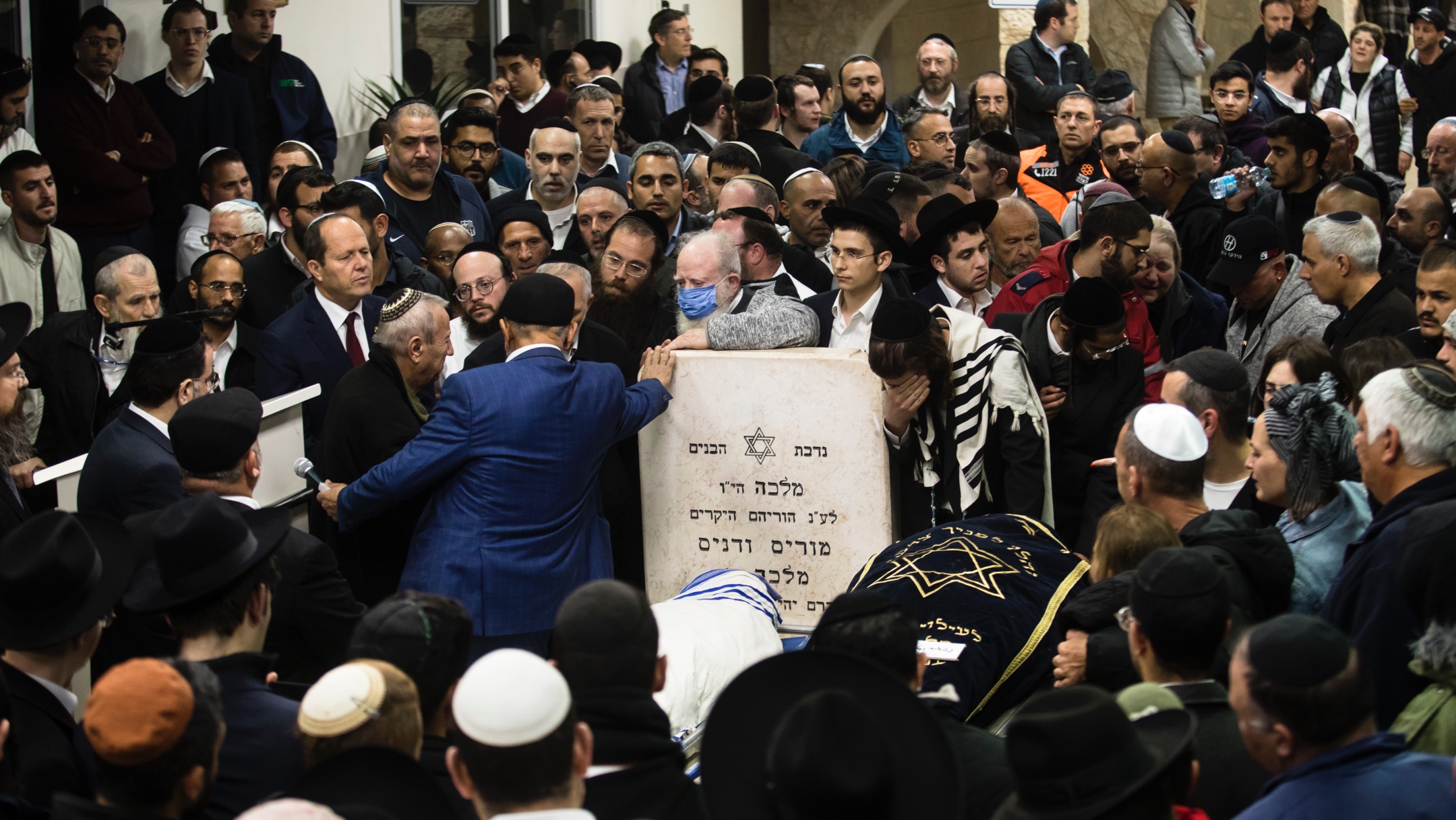 Family and friends of Eli and Natali Mizrahi, who were killed in a shooting attack in Jerusalem, mourn during their funeral in Bet Shemesh, jan. 28, 2023. (Amir Levy/Getty Images)