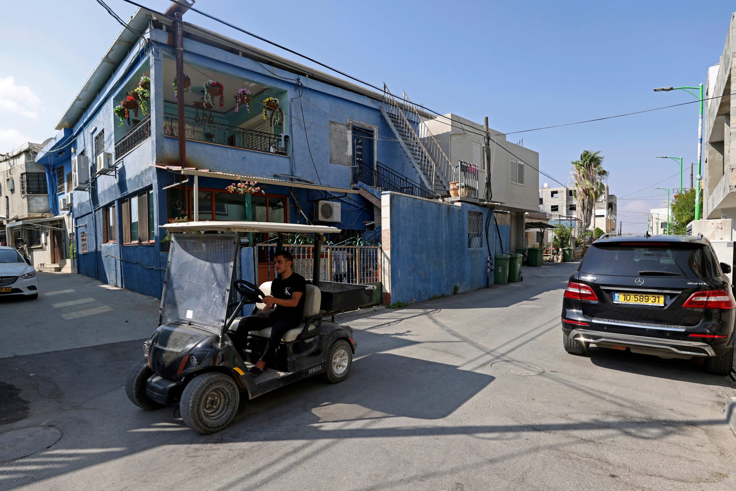 A man drives a golf kart in Ghajar, Sept. 7, 2022. (Jalaa Marey/AFP via Getty Images)