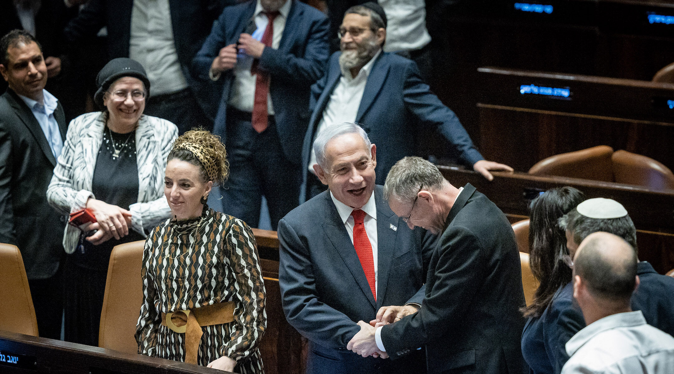 Israeli Prime Minister Benjamin Netanyahu and his allies celebrate a vote advancing key pieces of his coalition's judicial reform. (Yonatan Sindel/Flash90)