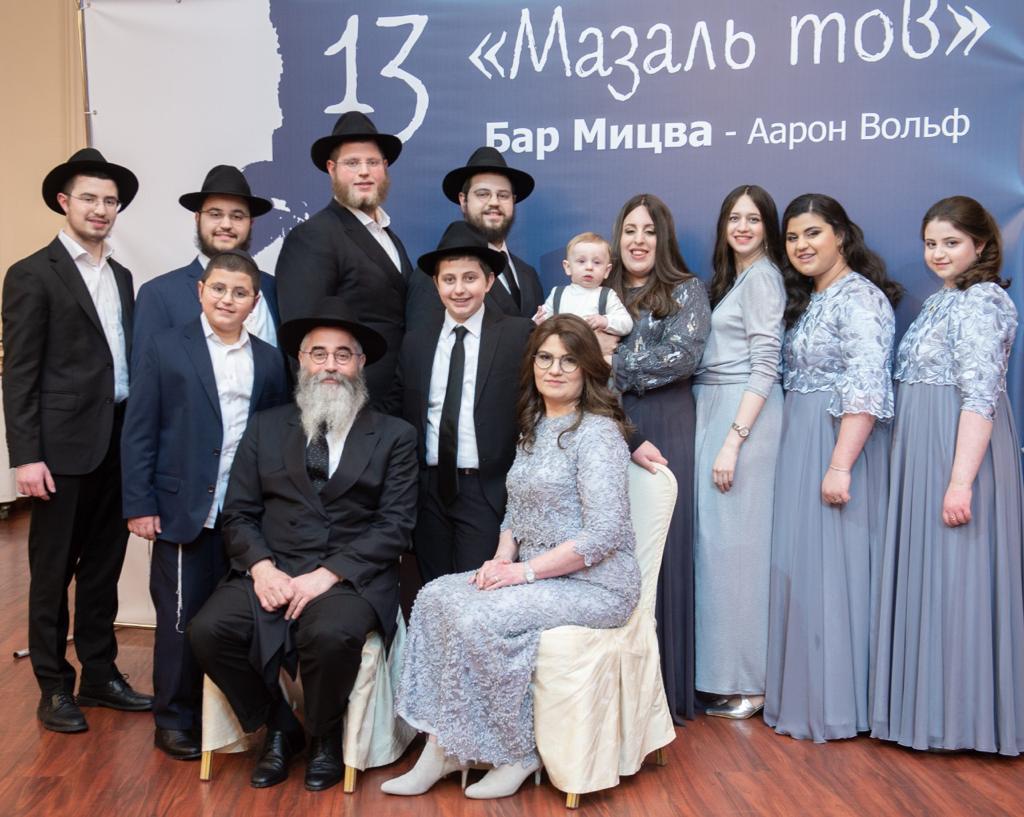 The Wolff family operates Chabad of Odessa. Rabbi Avraham and Chaya Wolff are sitting. Rabbi Mendy Wolff, who has overseen the children relocated from the group’s orphange to Berlin, is at the center in the back row. (Courtesy Chabad Odessa)