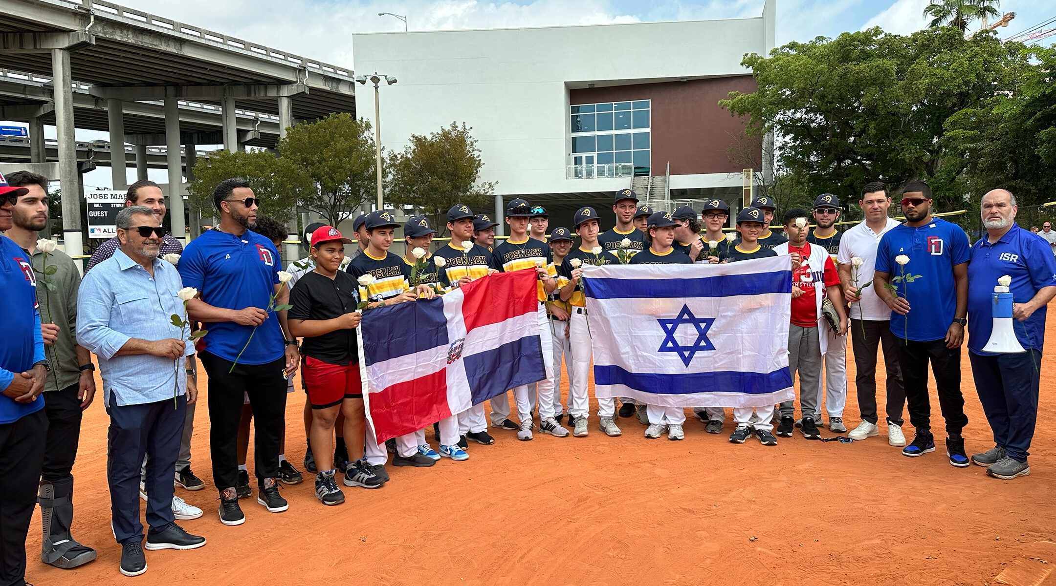 Teens pose with the Israeli and Dominican flags