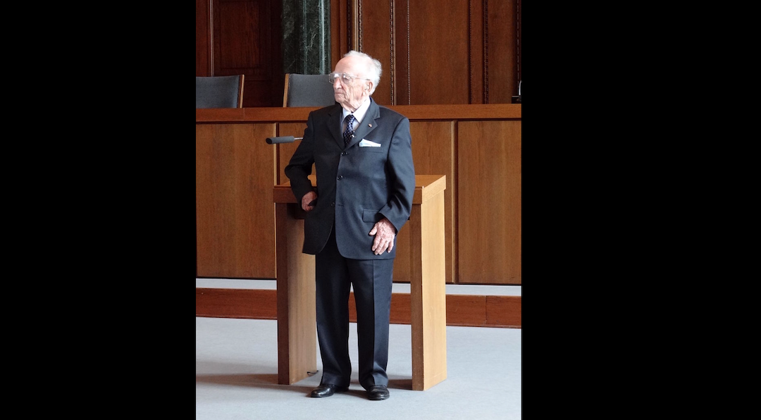 In 2012, Benjamin Ferencz poses in Courtroom 600 of the Palace of Justice, where the Nuremberg Trials were held 65 years earlier. (Adam Jones/Wikipedia)