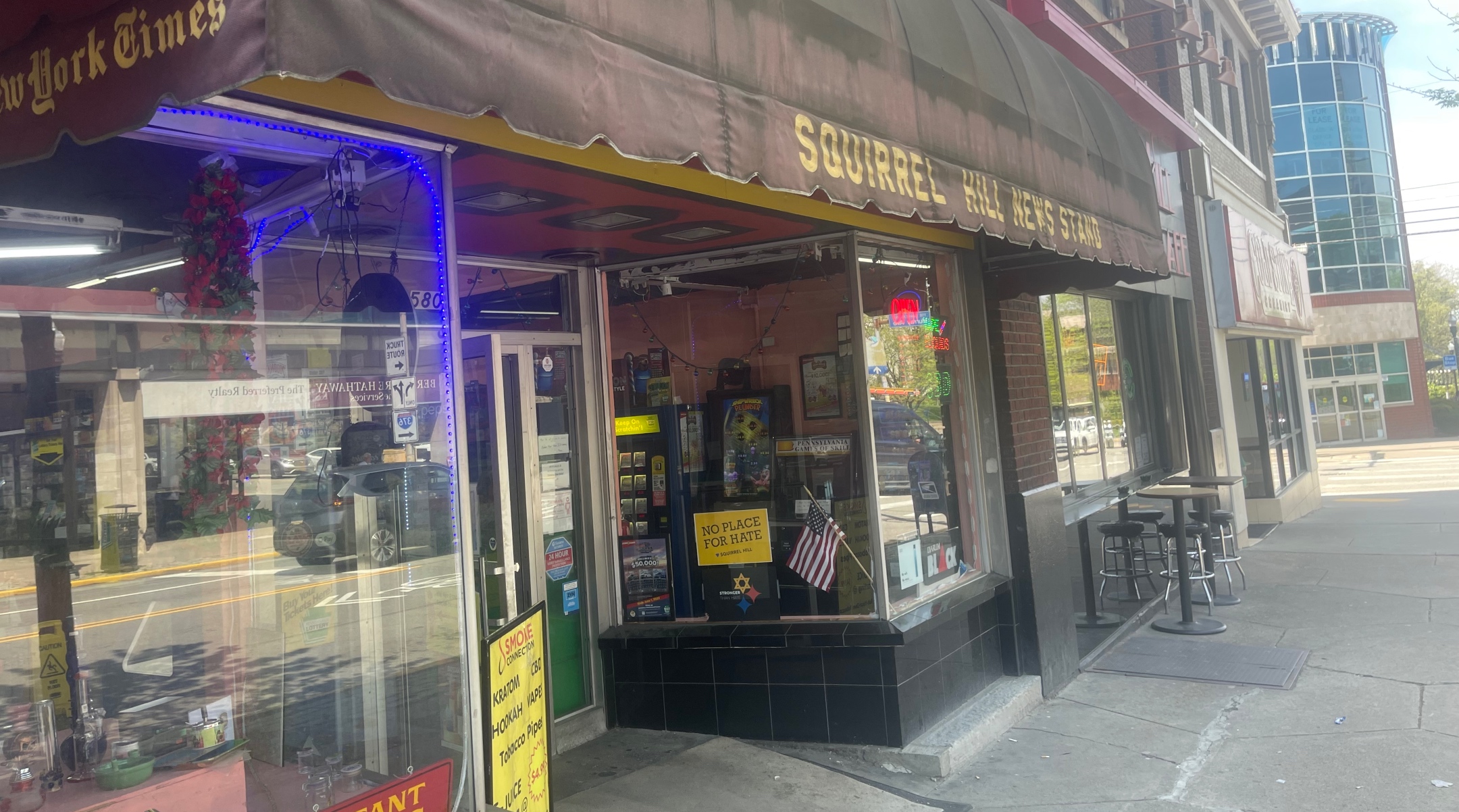 A tobacconist window includes a poster of the “No Place for Hate” slogan that proliferated after the Tree of Life Massacre in 2018, in Pittsburgh, April 21, 2023. (Ron Kampeas)