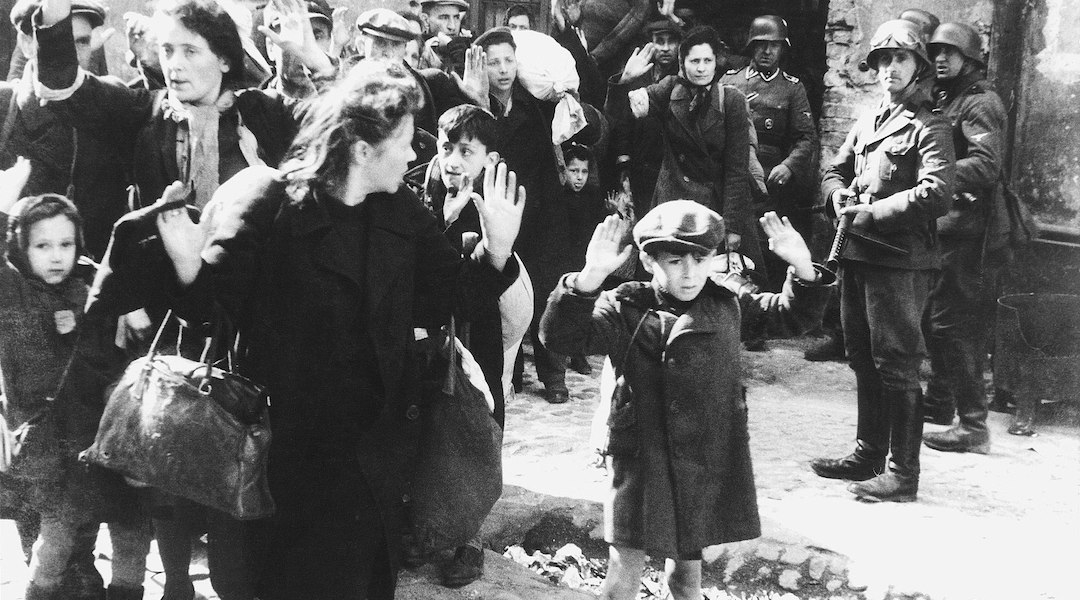 An iconic photo from the Warsaw Ghetto shows Jews being led by Nazis in 1943. (U.S. Holocaust Museum/Wikimedia Commons)