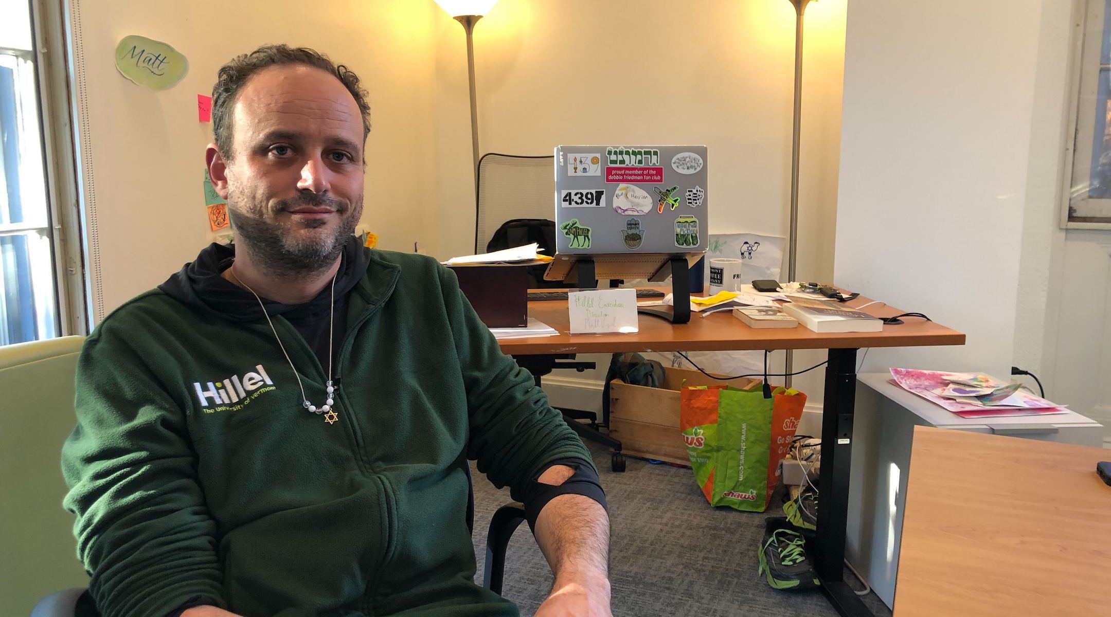 Matt Vogel, executive director of Hillel at the University of Vermont, prepares for Shabbat in his Burlington office, October 14, 2022. Vogel praised the university for ultimately resolving its federal antisemitism complaint in April 2023 after months of tension. (Andrew Lapin/Jewish Telegraphic Agency)