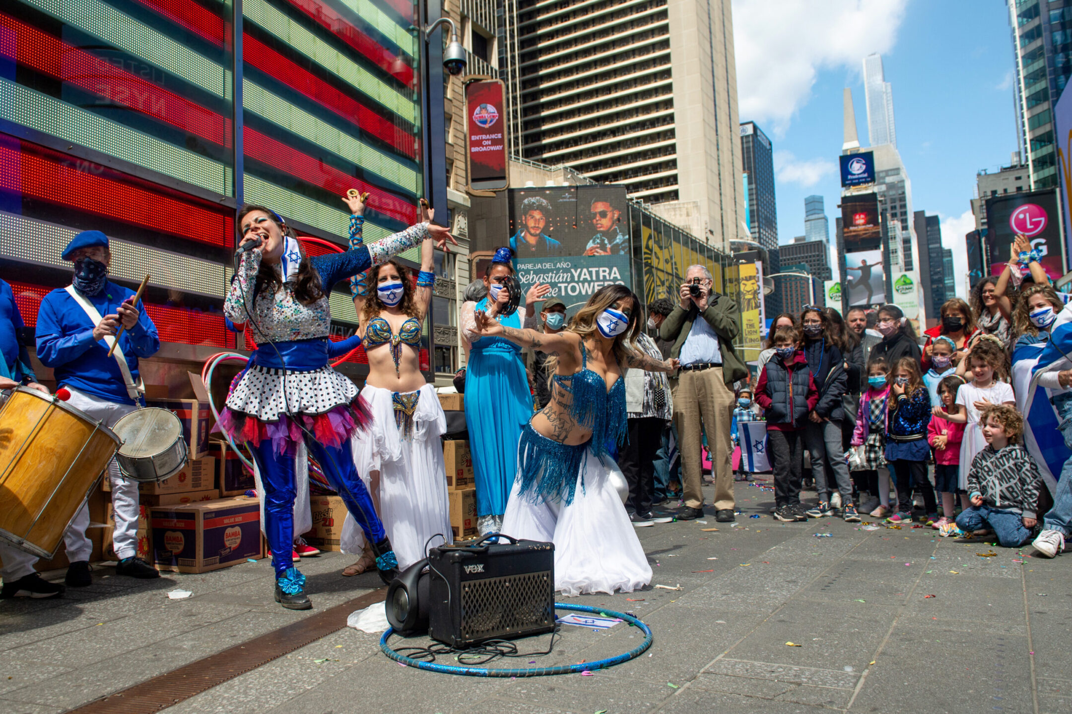 People gather to watch performers from the Independent Women Dance Troupe during celebrations marking Israel’s 73rd Yom Haatzmaut (Independence Day) in New York City’s Times Square, April 18, 2021.(Alexi Rosenfeld/Getty Images)