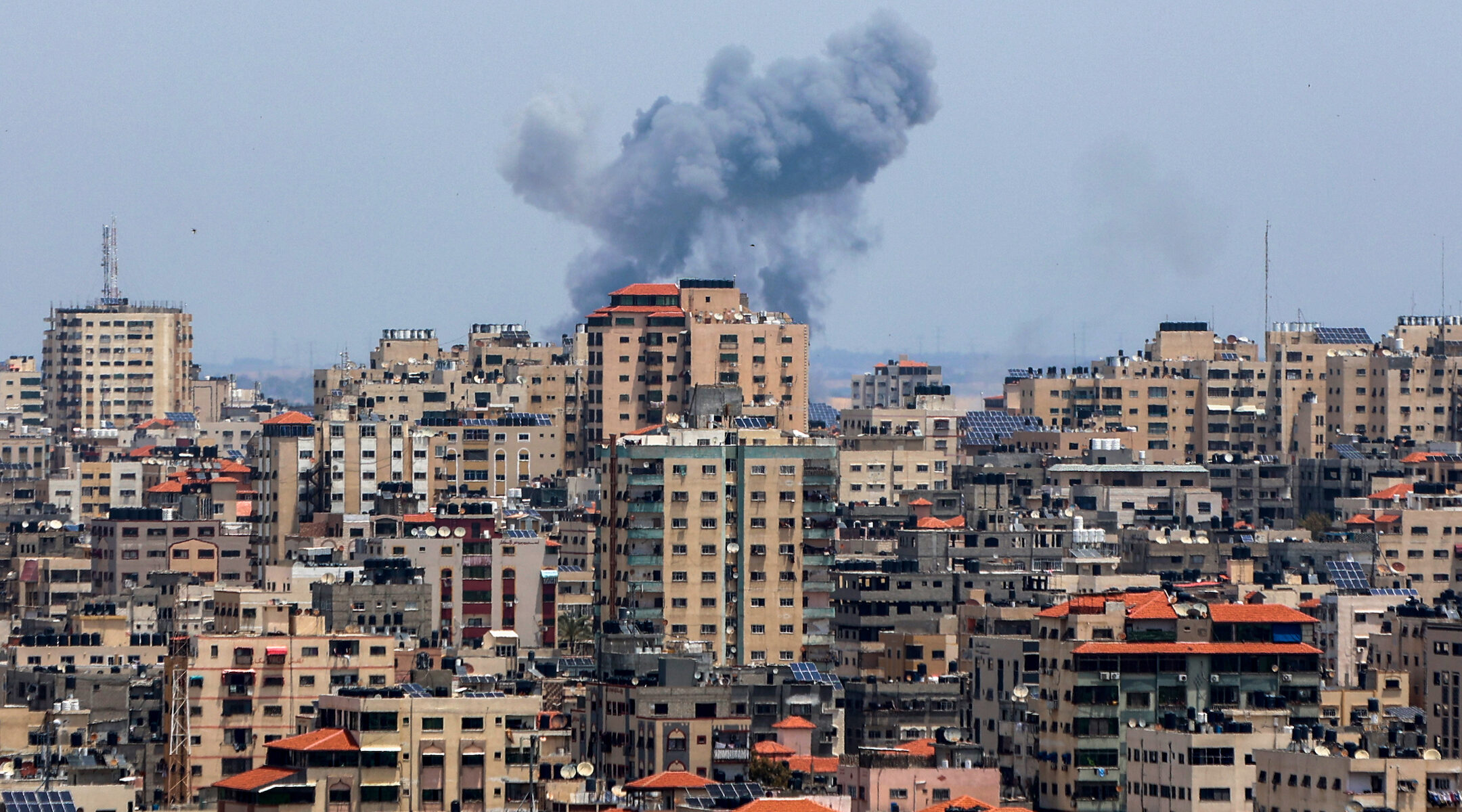 Smoke rises above buildings following airstrikes by Israel in Gaza City on May 12, 2023. (Atia Mohammed/Flash90)