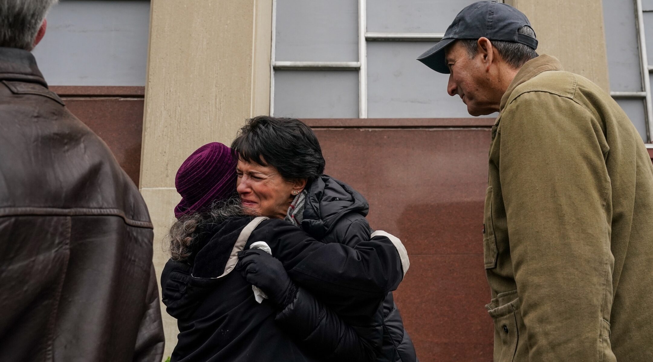 Andrea Wedner, center, one of two worshippers who were shot but survived in the 2018 Tree of Life Synagogue shooting, gets an emotional embrace at the conclusion of a ceremony to say l'hitraot, or until we see each other again, to the Tree of Life building ahead of planned construction in Pittsburgh on April 23, 2023. ( Jahi Chikwendiu/The Washington Post via Getty Images)