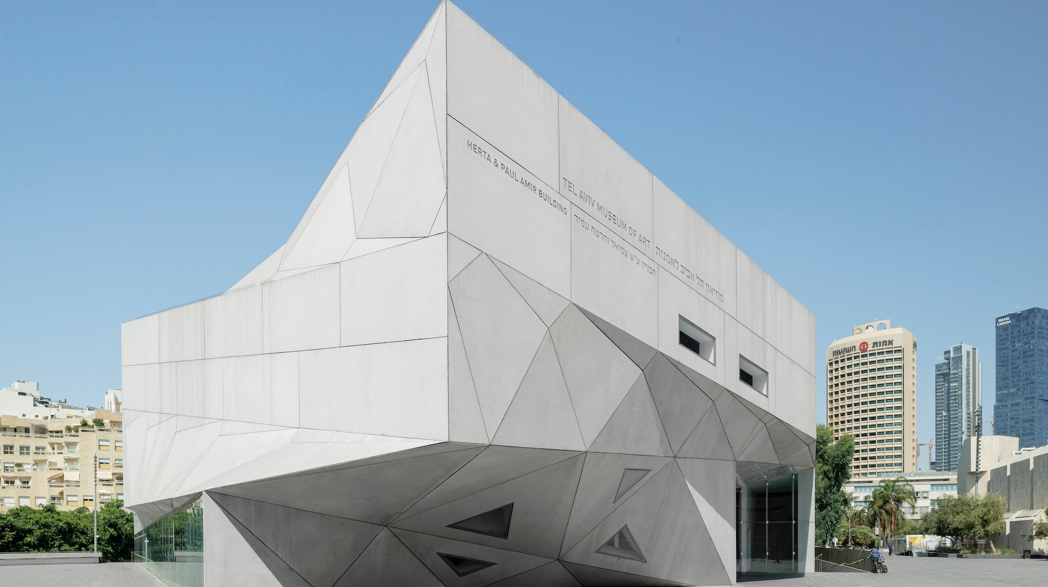 The museum building has a white, Origami-like design and contemporary architectural style.