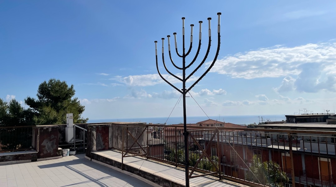 The rooftop of the Castello Leucatia, where the community meets, has a large menorah and a view of the Mediterranean. (David I. Klein)