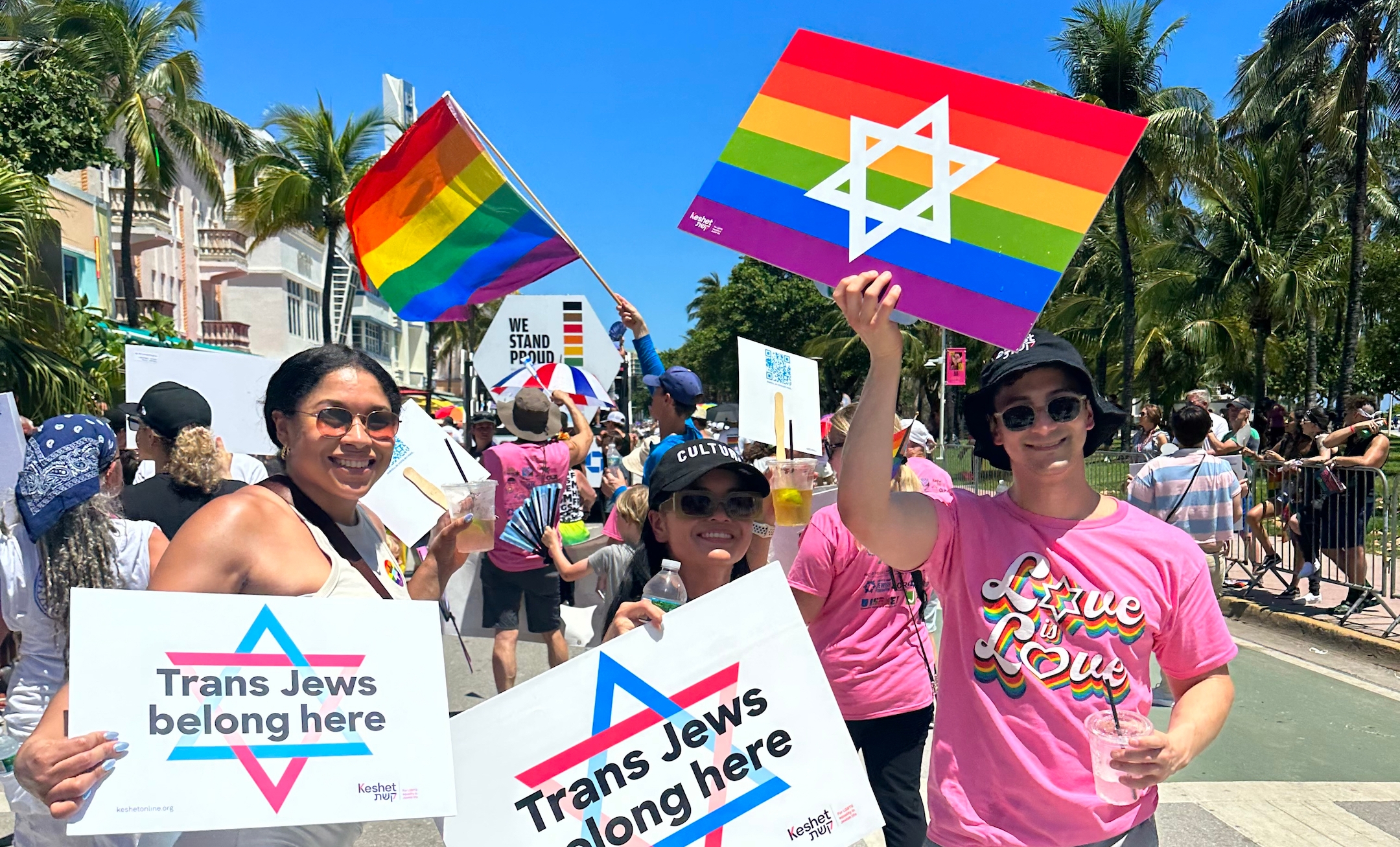 Jews marching with signs reading "Trans Jews Belong Here"