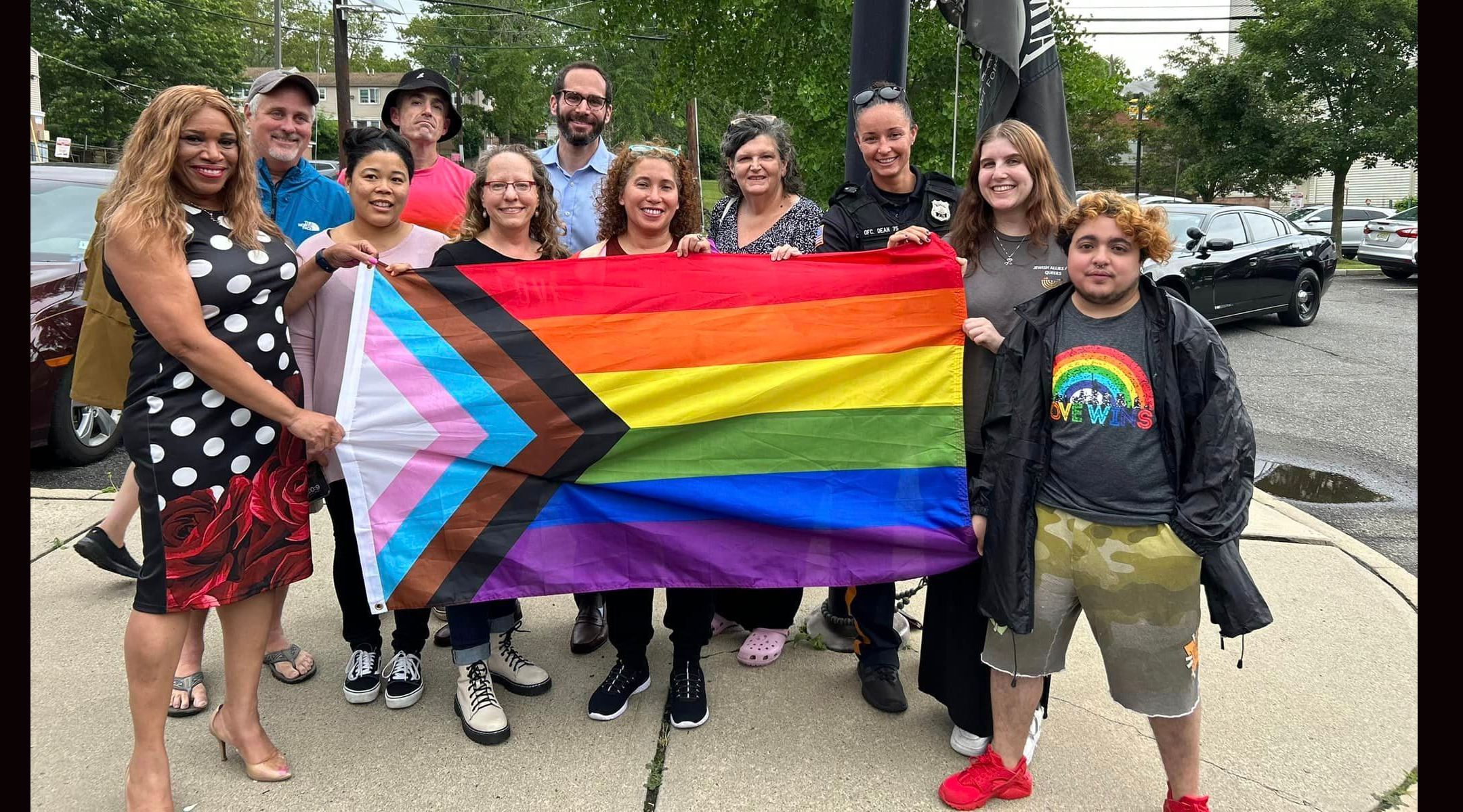 Highland Park Mayor Elsie Foster, left, participates in a raising of Pride flags in the city, June 26, 2023. Foster had ordered four Pride flags removed from a public street weeks prior at the request of two local rabbis. (City of Highland Park)