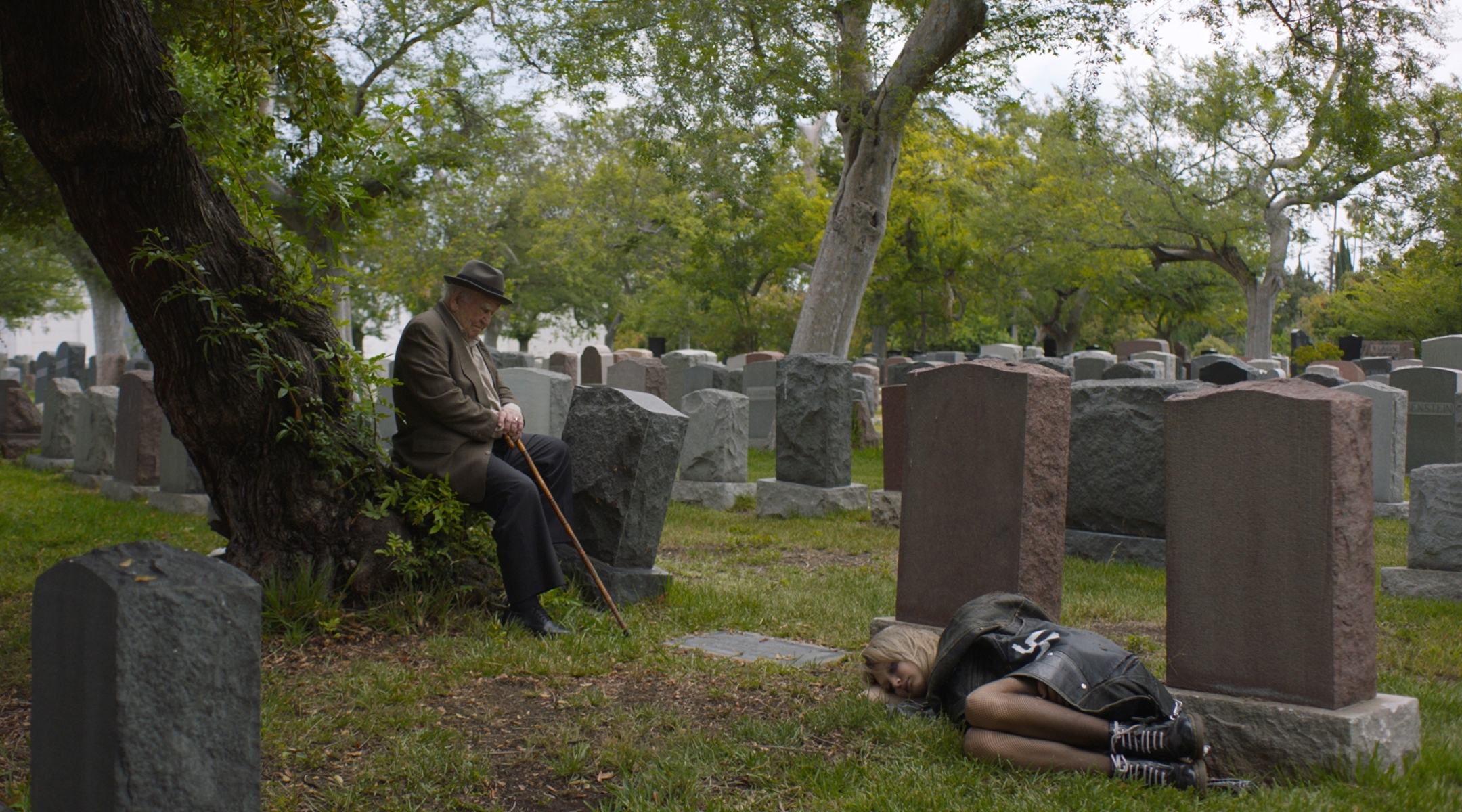 Samuel (Ed Asner) discovers Casey (Margot Josefsohn) sleeping in a cemetery in a scene from “Tiger Within.” (Courtesy of Menemsha Films)