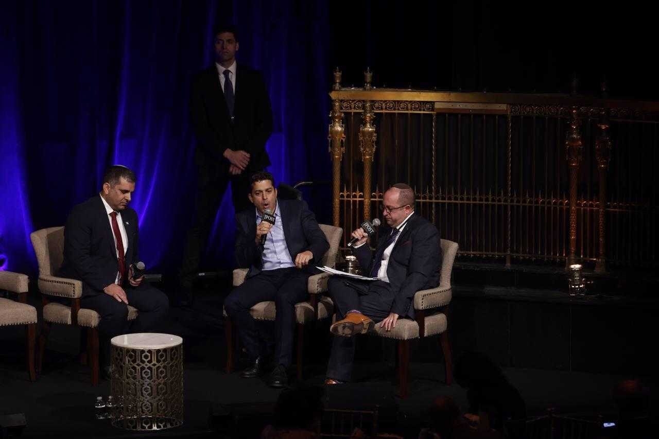 Israeli Immigration and Absorption Minister Ofir Sofer (left) and Diaspora Affairs Minister Amichai Chikli (center) appear onstage at the Jerusalem Post Conference in New York City on June 5, 2023. (Marc Israel Sellem)