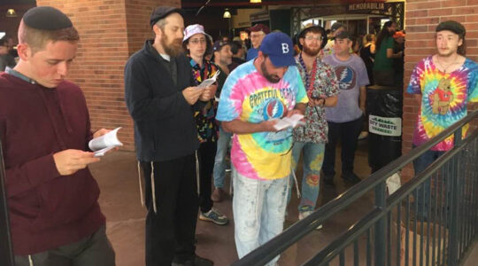 Kalb, center, leads a crowd of Jewish Deadheads in prayer at Citi Field's Jackie Robinson Rotunda on June 21, 2023. (Courtesy)