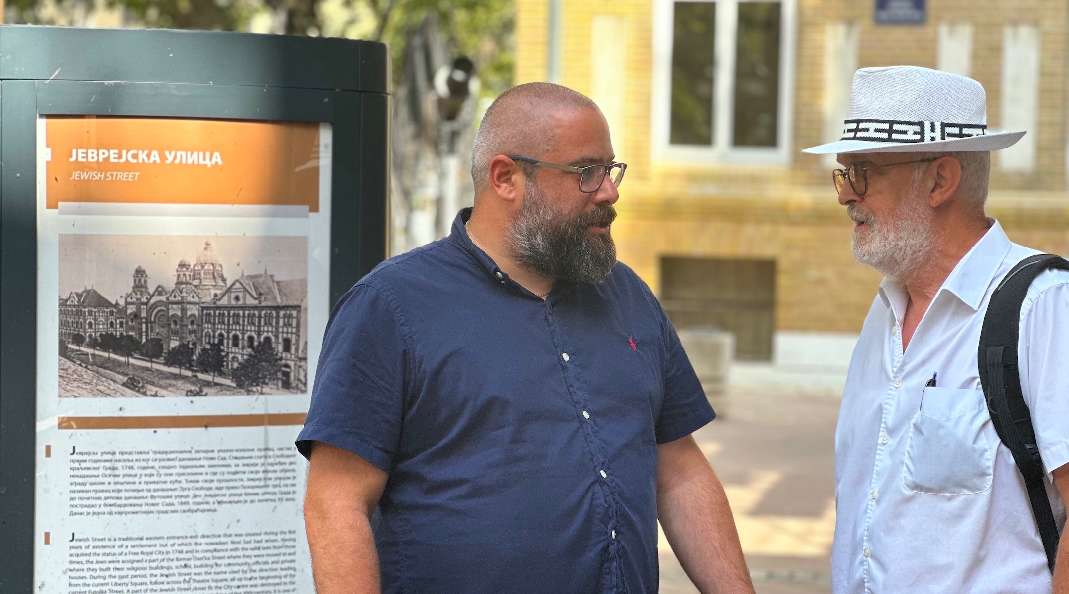 Ladislav Trajer, left, and Mirko Štark, the top two leaders of the Jewish community in Novi Sad, chat just outside the entrance to their synagogue. (Larry Luxner)