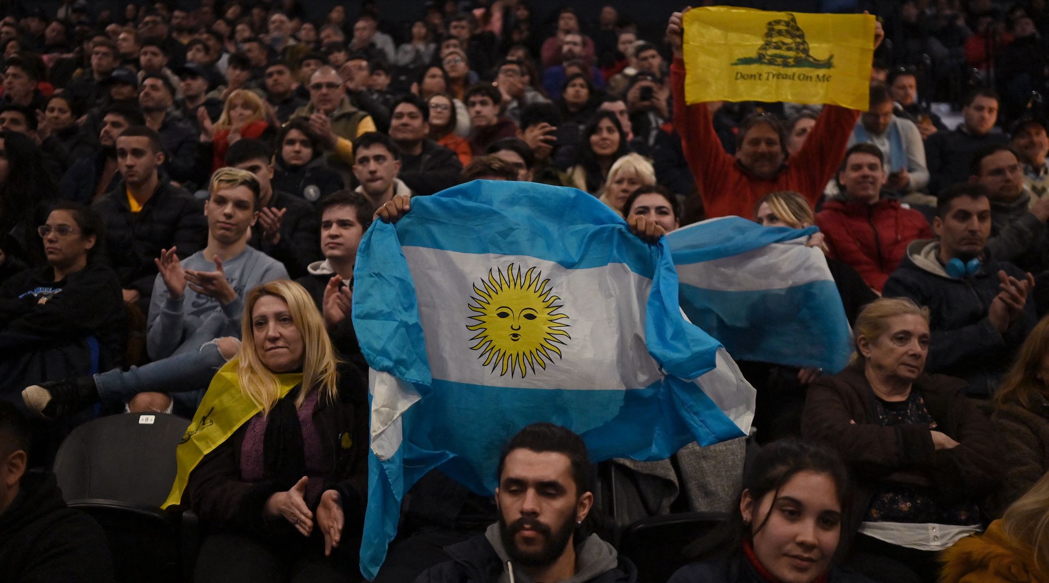 Milei supporters display an Argentine national flag and a “Don’t tread on me” flag during a rally at the Movistar Arena in Buenos Aires, Aug. 7, 2023. (Luis Abayo/AFP via Getty Images)