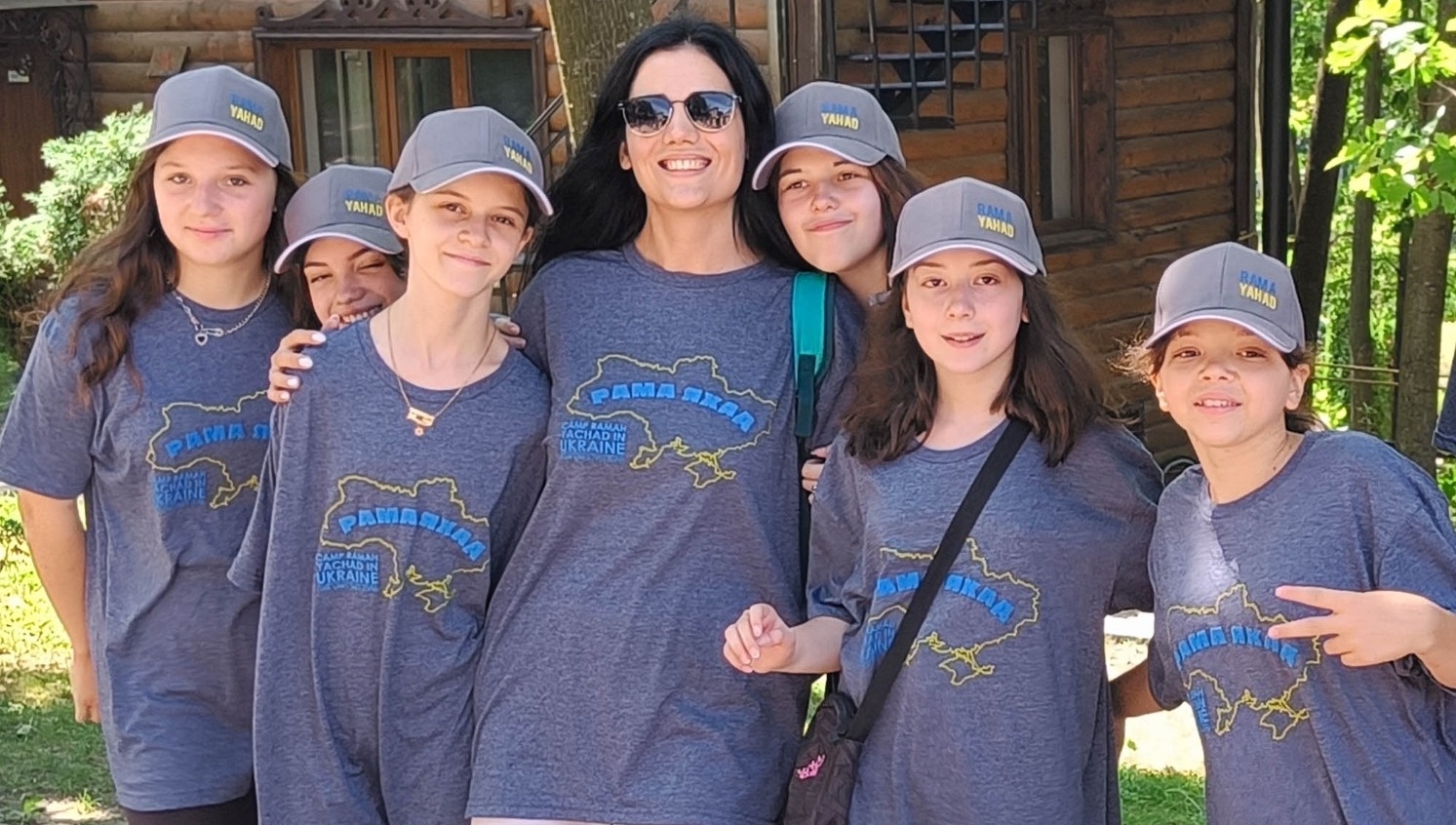 Campers and a counselor at Ramah Yachad pose in their 2023 T-shirts, showing an outline of Ukraine for the first session in the country since Russia invaded in 2022. (Courtesy Midreshet Schechter)