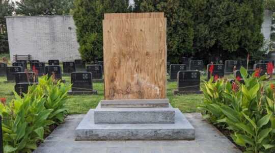 A boarded-up memorial in a cemetery