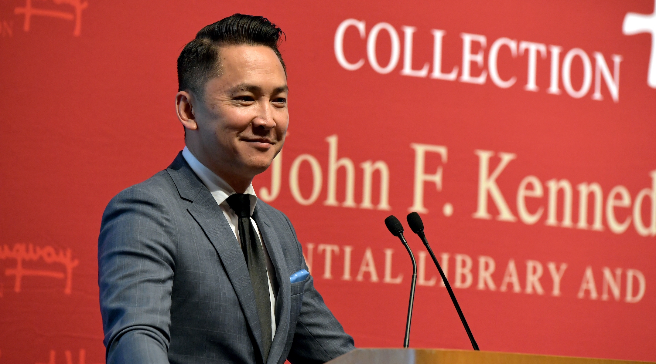 An author speaking at a podium