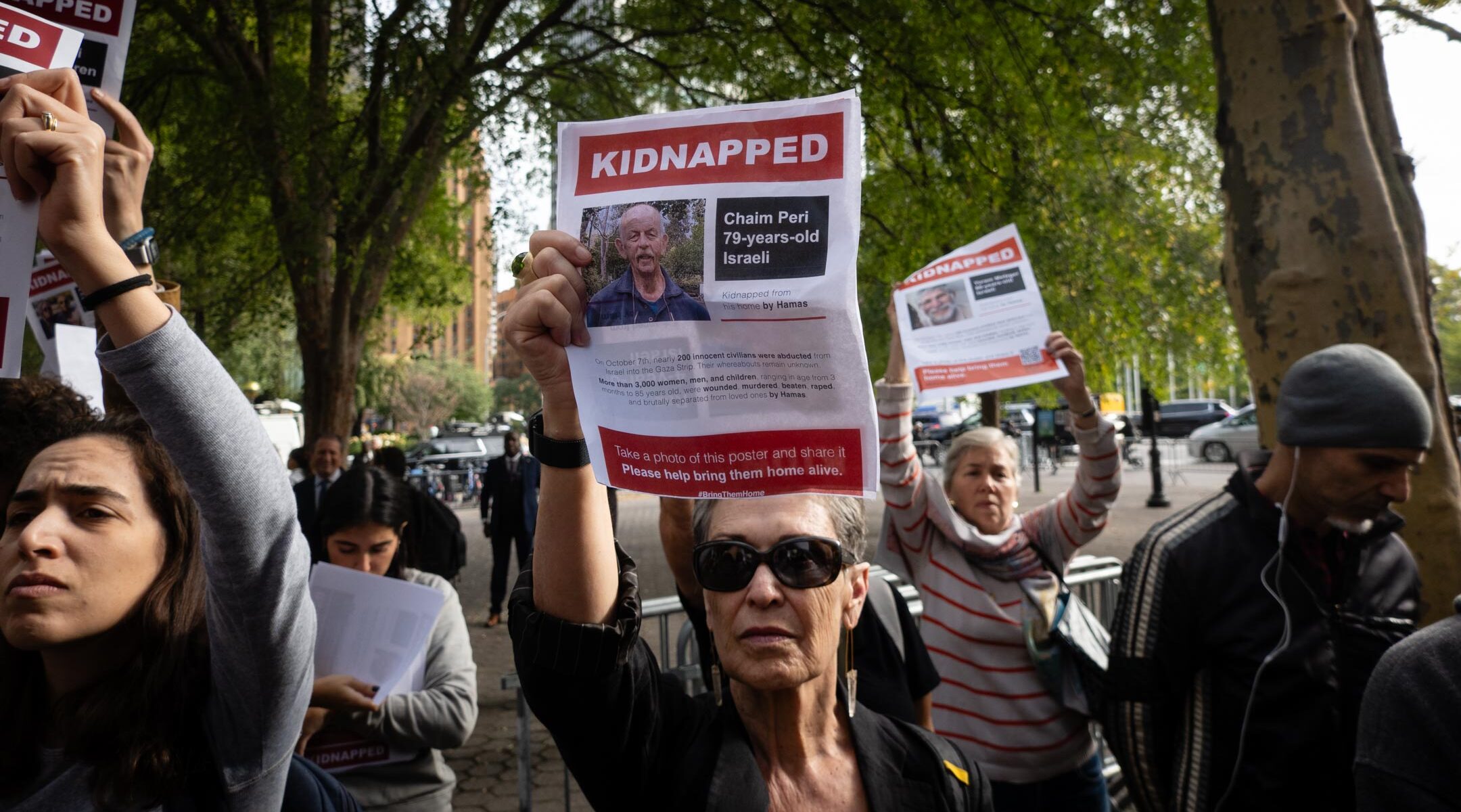 Israel supporters hold images of Hamas hostages at a rally demanding their release, in New York City, October 18, 2023. (Luke Tress)