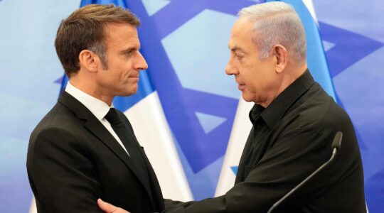 French President Emmanuel Macron shakes hands with Israeli Prime Minister Benjamin Netanyahu