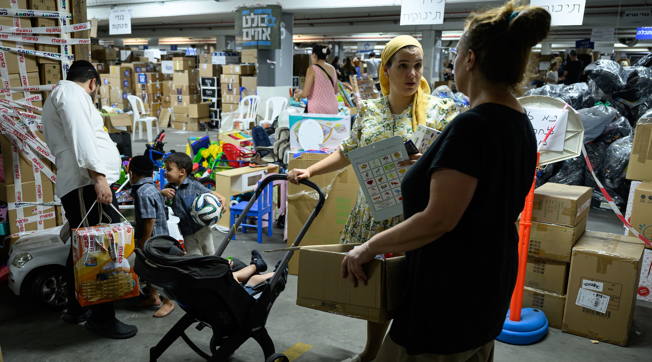 A member of the haredi community collects a selection of toys from a donation center set up for those who have been forced to flee their homes following the Hamas attacks of Oct. 7.(Leon Neal/Getty Images)