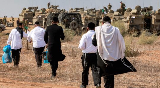 Haredi Jews visit Israeli soldiers to show their support as they deploy at a position near the border with Gaza in southern Israel on October 11, 2023. (Menahem Kahana/AFP via Getty Images)