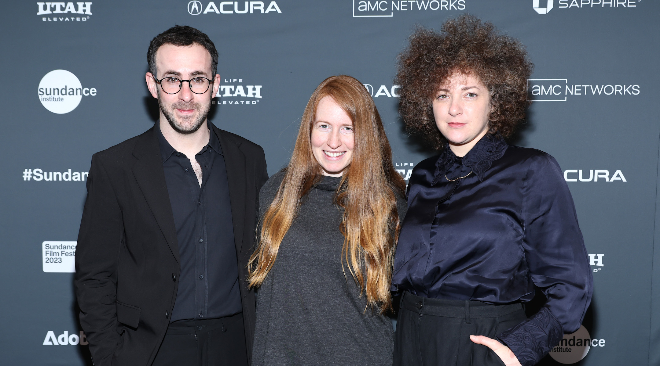 People posing on a red carpet