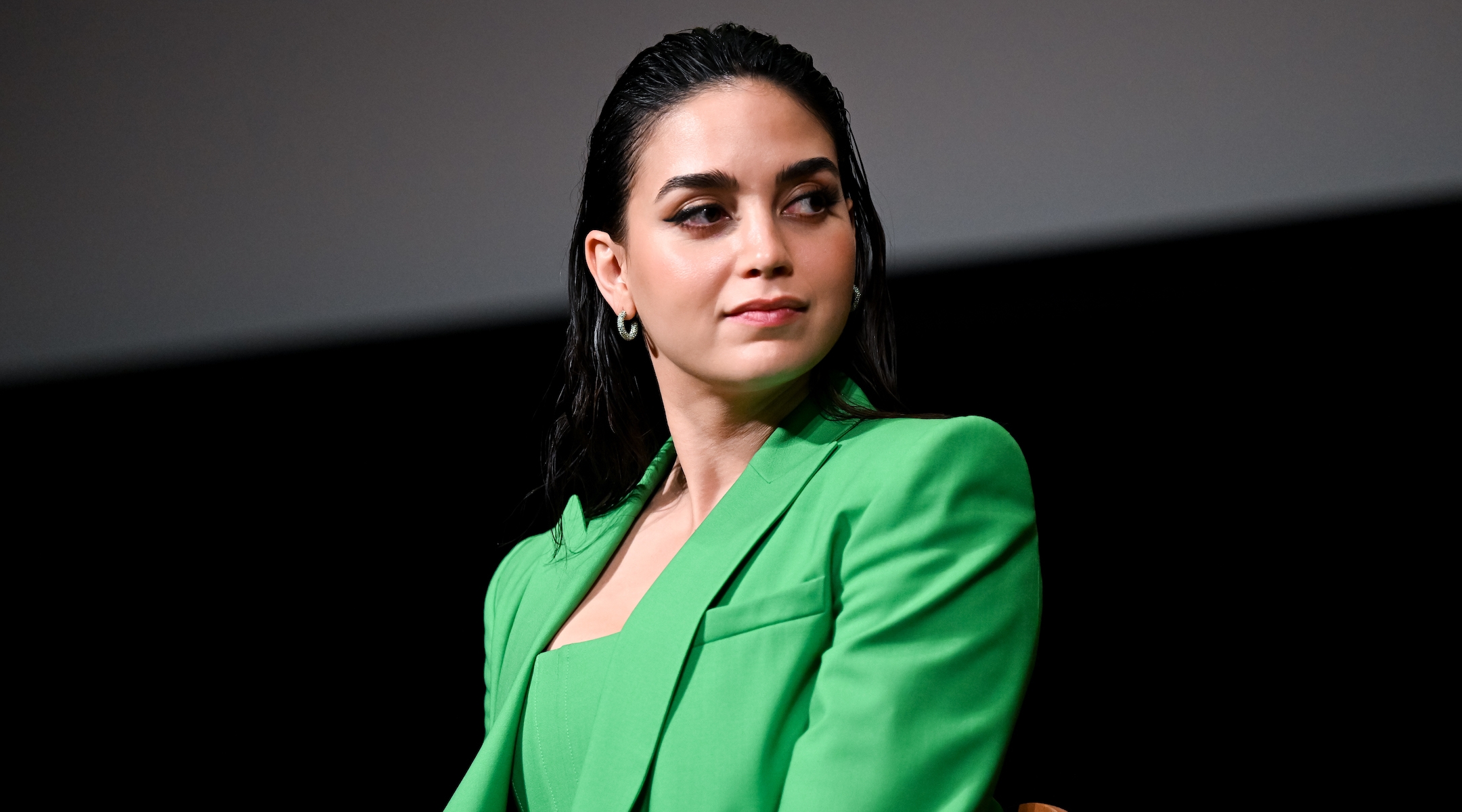 Actress Melissa Barrera wearing a green dress at a premiere screening