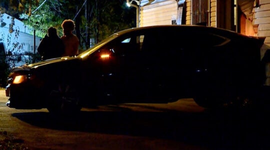 A car damaging a building