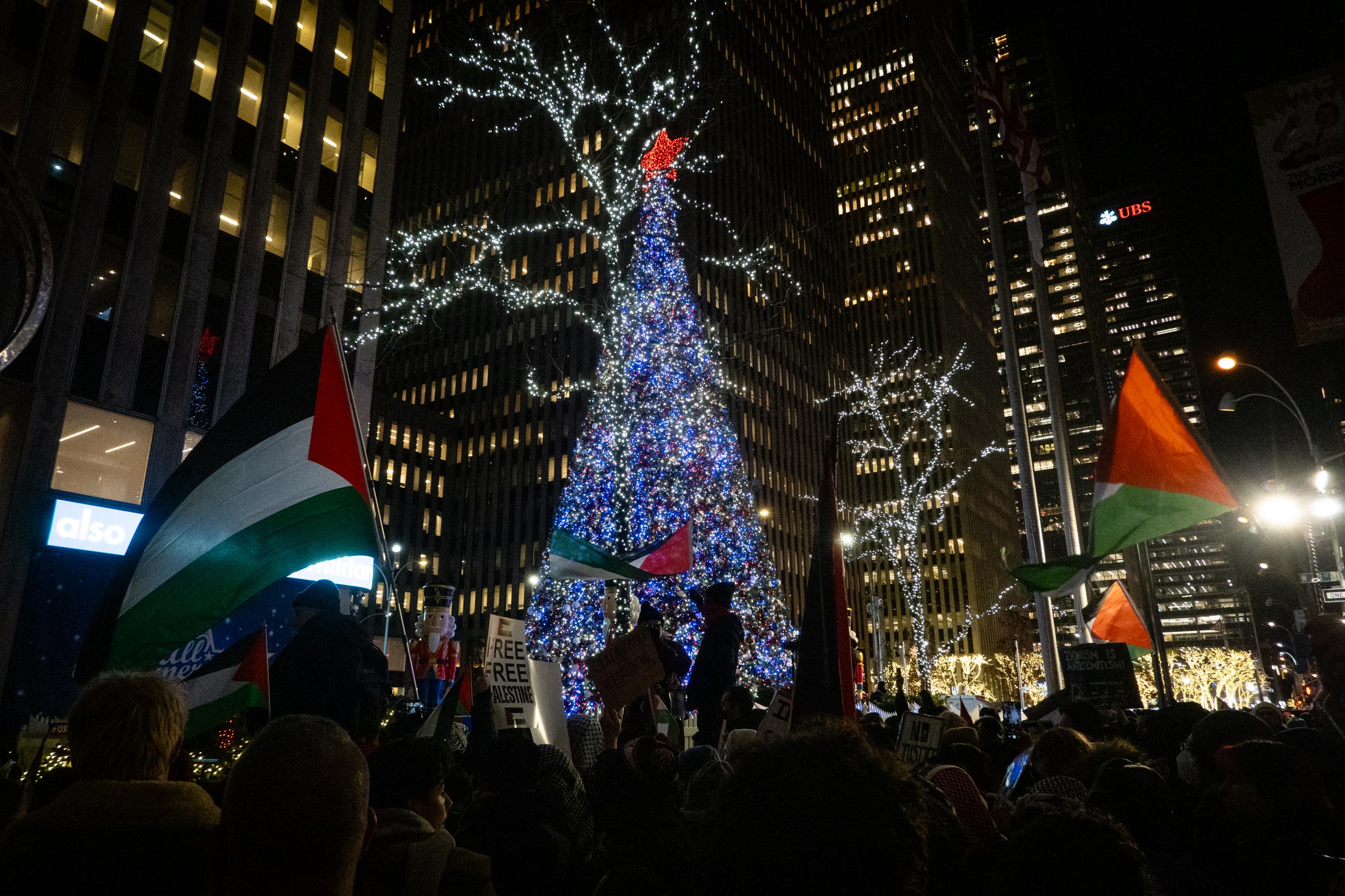 Anti-Israel demonstrators hold a rally against the Rockefeller Christmas tree lighting, in New York City, November 29, 2023. (Luke Tress)