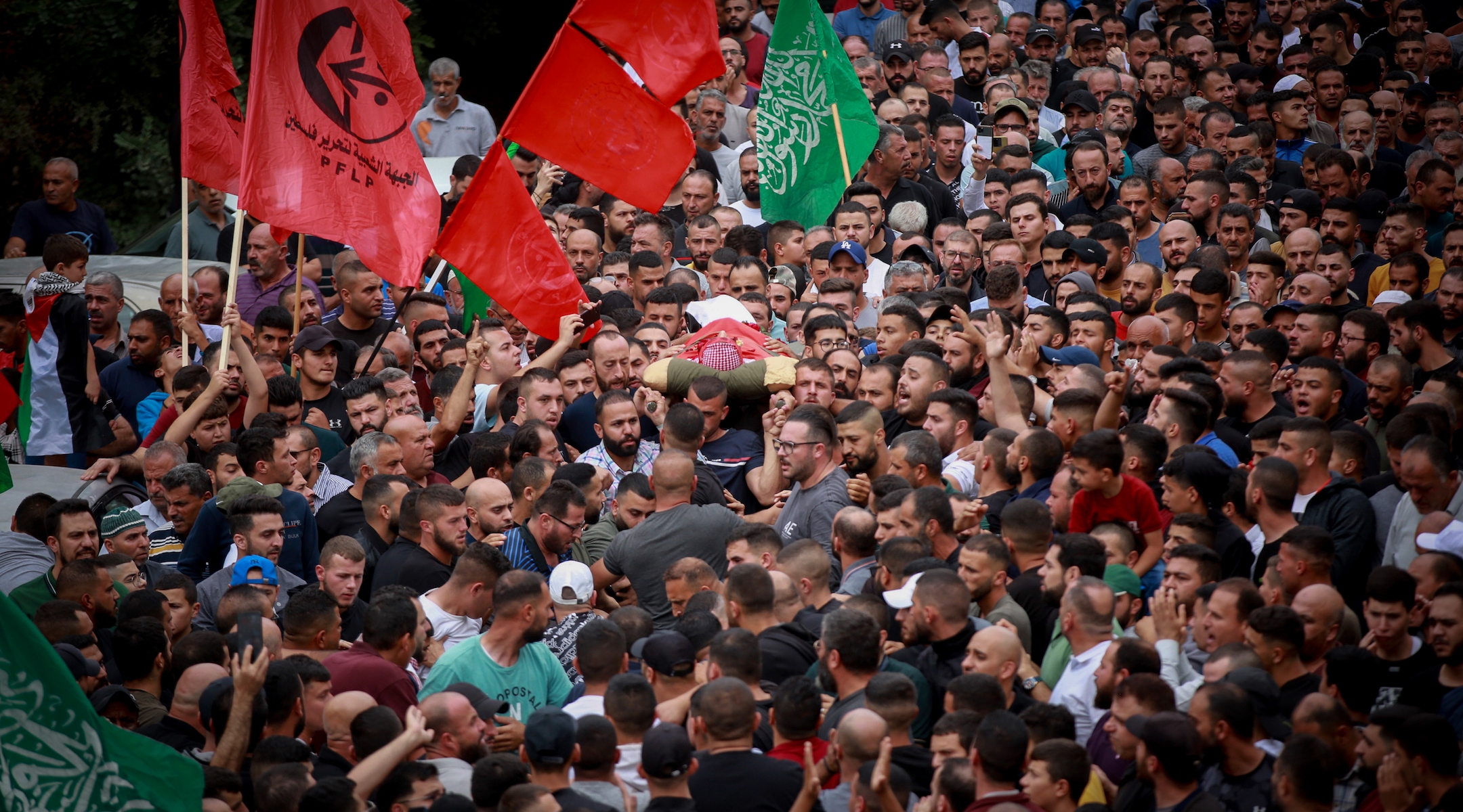 Palestinians mourn Nasser Barghouti during his funeral in the West Bank village of Beit Rima, northwest of Ramallah, Sunday, Oct. 29, 2023. (Flash90)