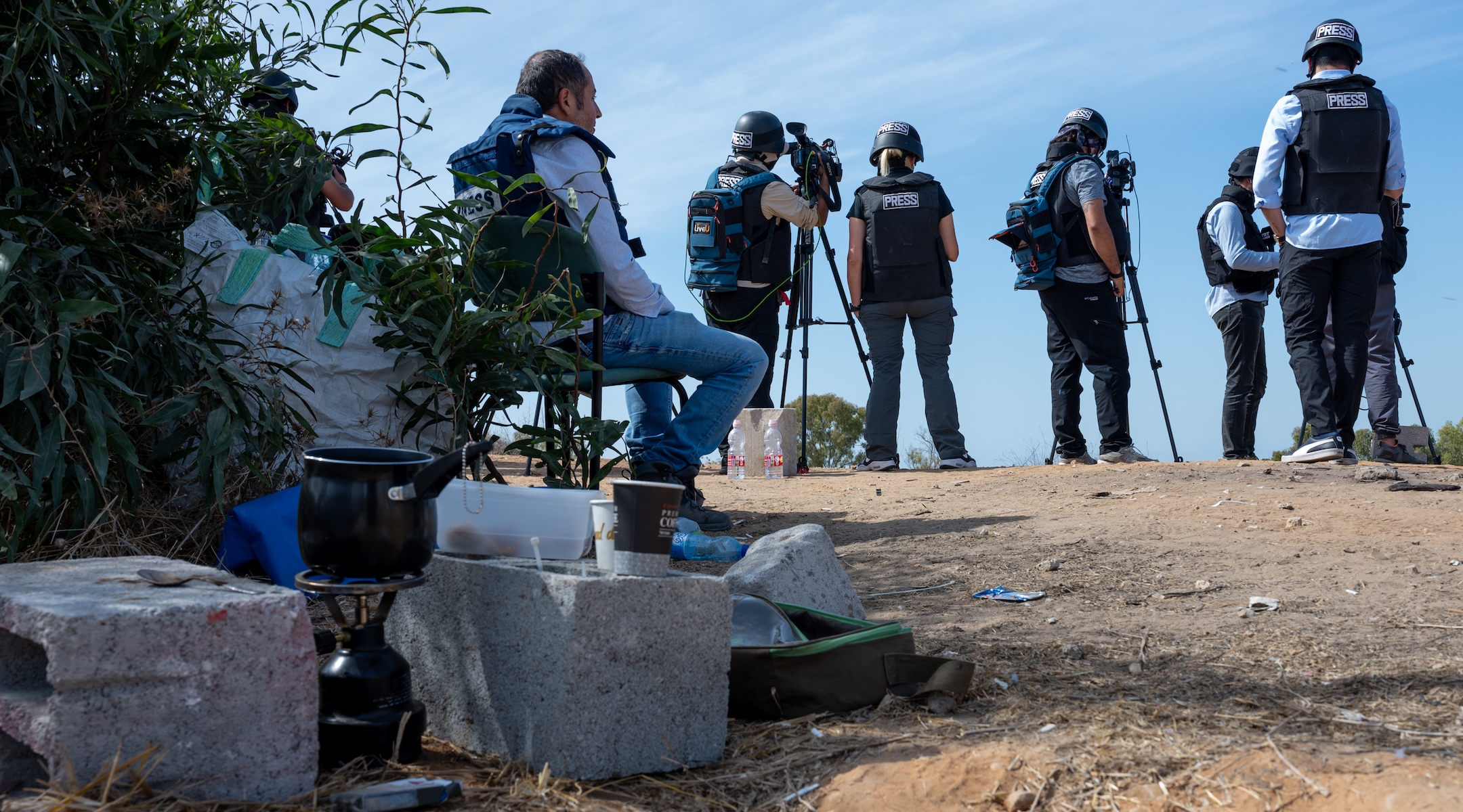 Members of the press wait on an overlook to report rocket attacks from Gaza, or Israeli bombardments, on October 21, 2023 in Sderot, Israel. (Alexi J. Rosenfeld/Getty Images)
