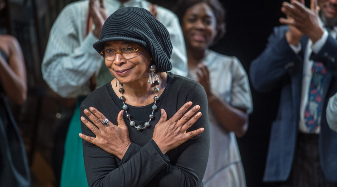 Author Alice Walker takes a bow onstage as a Broadway cast stands and claps behind her