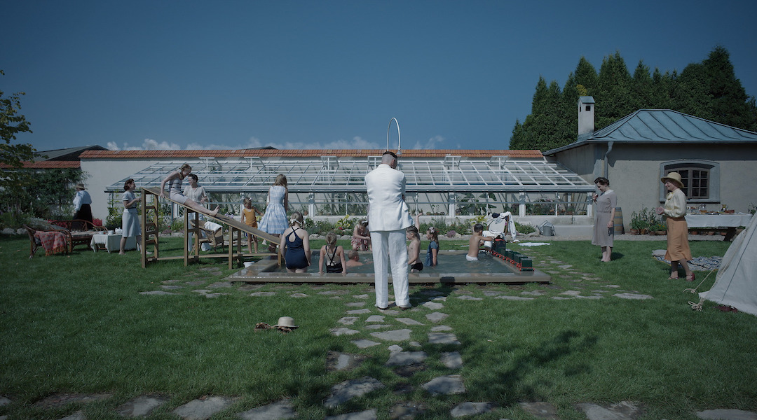 A Nazi commander looks at his family's garden in the shadow of Auschwitz in a scene from "The Zone of Interest"