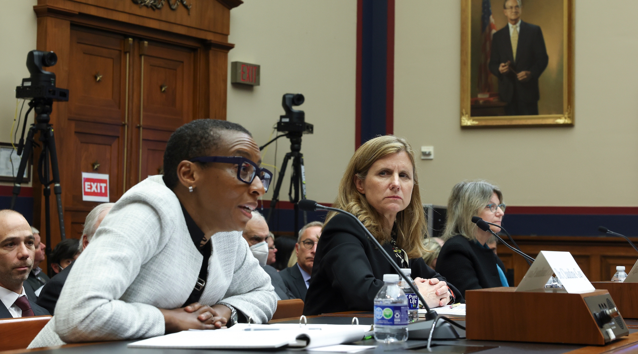 Three university presidents sitting at a witness table in front of the U.S. Congress.