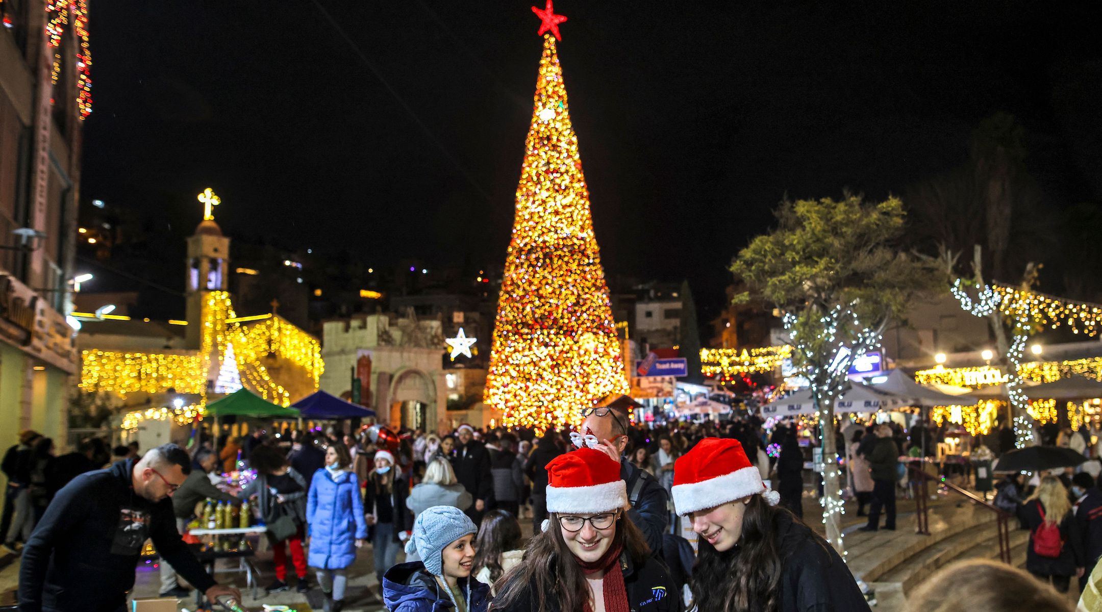 People gathering at Nazareth's Christmas tree ahead of the holiday in 2021.(Ahmad Gharabli/AFP via Getty Images)